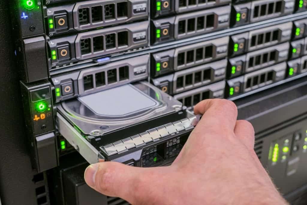 Technician sliding a hot-swap drive into a storage server