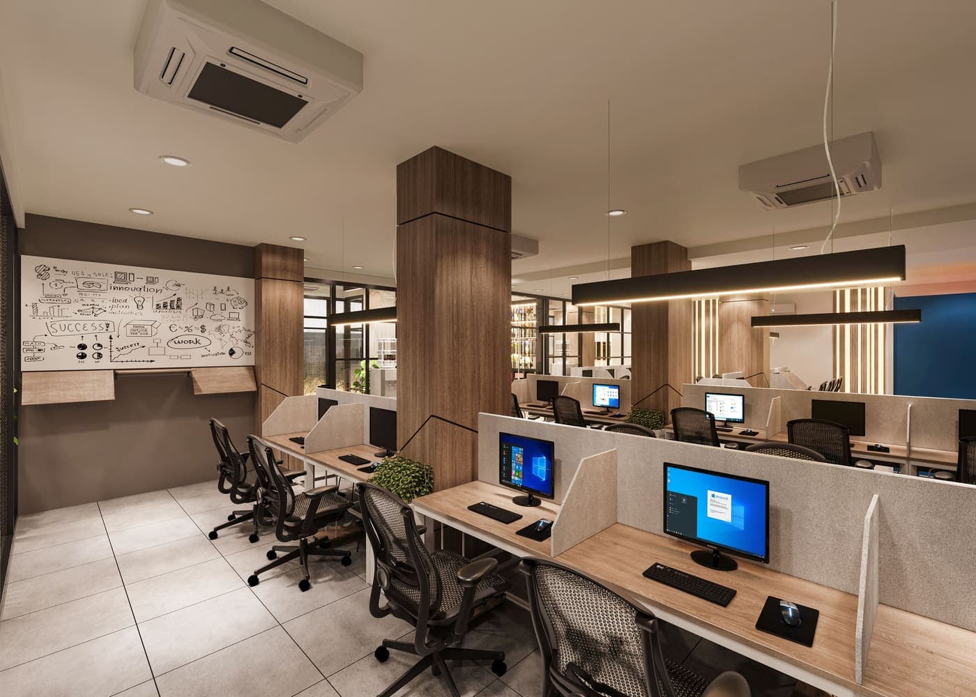 Open office with rows of desks, monitors and chairs